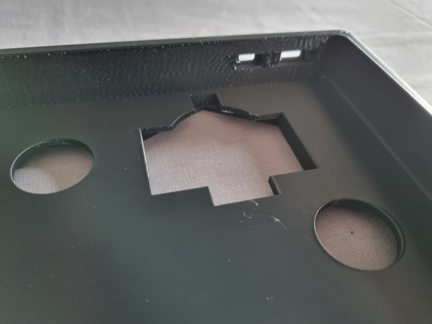 A close-up inside the main enclosure, showing holes for the display and LED wiring, and slots in the side wall for the USB-C port and power slide switch. A close-up inside the main enclosure, showing holes for the display and LED wiring, and slots in the side wall for the USB-C port and power slide switch.