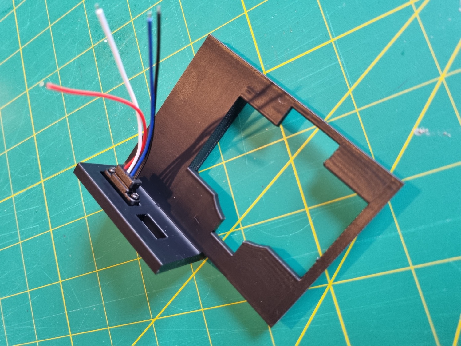 An early prototype test print of a section of the main enclosure showing the USB-C port and power slide switch fitted in their slots, from behind. The USB-C port can be seen screwed into the wall. An early prototype test print of a section of the main enclosure showing the USB-C port and power slide switch fitted in their slots, from behind. The USB-C port can be seen screwed into the wall.
